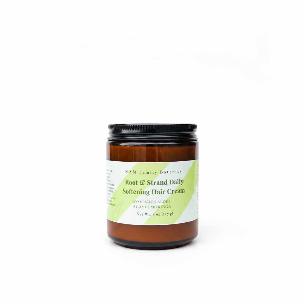 Jar of KAM Family Botanics Root & Strand Daily Softening Hair Cream on a surface with a blurred background
